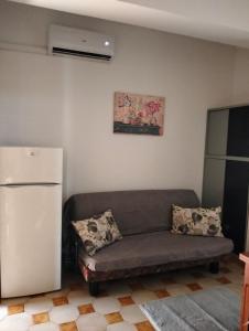 a living room with a couch and a refrigerator at Lavinia House in Oliveri