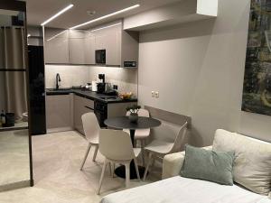 a kitchen and a table and chairs in a room at ANAVASI Loft SUITE in Alexandroupoli