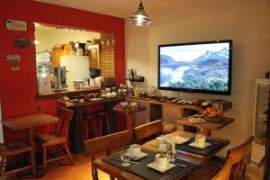 a dining room with a television on a wall at Hotel Boutique Terra Diaguita & Spa in La Serena