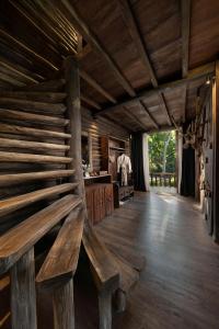 a wooden bench sitting in the middle of a room at P'apiu Resort in Ha Giang