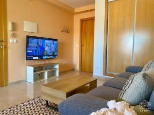 a living room with a couch and a tv at La Sort - Castillo in Valderrobres