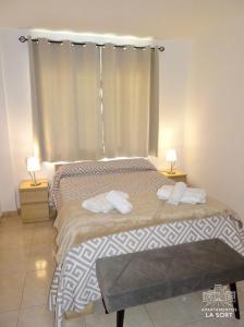 a bedroom with a bed with two towels on it at Ático La Sort con vistas al castillo in Valderrobres