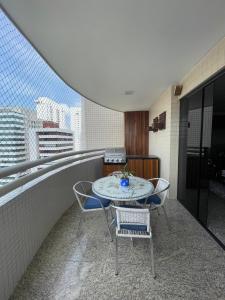 a patio with a table and chairs on a balcony at Luxury Umarizal Accommodation COP30 in Belém