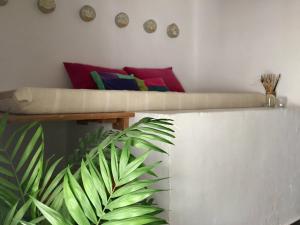 a couch sitting on top of a wall with a plant at Casa Baraka in Algodonales