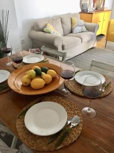 a table with glasses of wine and a plate of food at Casa Baraka in Algodonales +8 photos