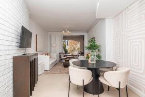 a living room with a table and chairs at Upscale 1BR with Large Balcony in Trendy De Waterkant in Cape Town