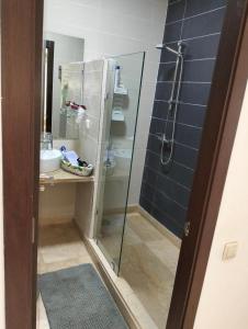 a bathroom with a glass shower and a sink at Pavillon Luxe - Jardin de l'Atlas - Golf & Waky in Sraghna