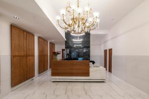 a lobby with a chandelier and a reception desk at Upscale 1BR with Large Balcony in Trendy De Waterkant in Cape Town +57 photos