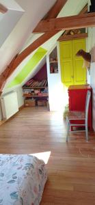 a attic room with yellow and green walls and a bed at Gîte 3 chambres dans Longère aux Rosiers-sur-Loire in Le Thoureil +6 photos
