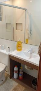 a bathroom with a sink and a mirror at Casa do Caiçara in Ubatuba