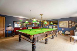 a living room with a pool table in it at Greenhill Farm Barn- Stunning Cotswold Barn with Billiards Room in Sutton under Brailes