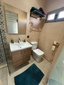 a bathroom with a sink and a toilet and a mirror at Villa Dar Hamza Marrakech in Tahannout