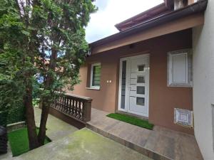a house with a porch and a white door at Sweet Lux Home 1 in Smederevo