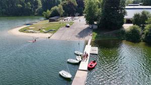 a group of boats docked at a dock in the water at Bütgenbach Ferienhaus Lorea in Butgenbach