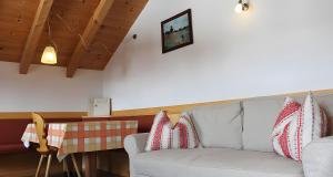 Una sala de estar con un sofá blanco y una mesa. en Ciablun, en La Valle