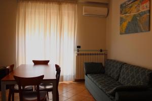 a living room with a couch and a table at Hotel L'AQUILA 99 in LʼAquila