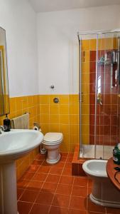 a bathroom with a sink and a toilet and a shower at Villa Mozia riserva dello Stagnone in Marsala