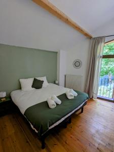 a bedroom with a large bed with two pillows on it at Oxxy Casa - Gîte de 14 personnes in Milhas