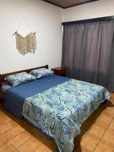 a bedroom with a bed with a blue comforter at Julius Apart in Eldorado