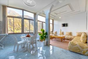 a living room with a couch and a table at Dar Ourika - Mountain Views in Ourika
