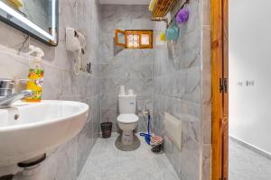 a bathroom with a white sink and a toilet at Dar Ourika - Mountain Views in Ourika +9 photos