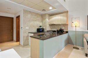 a kitchen with a counter top in a room at Elegant Studio with Yas Views in Abu Dhabi
