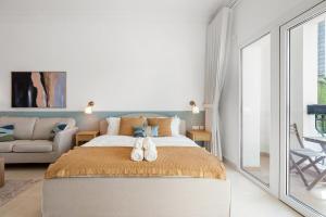 a bedroom with a large bed and a couch at Elegant Studio with Yas Views in Abu Dhabi +27 photos