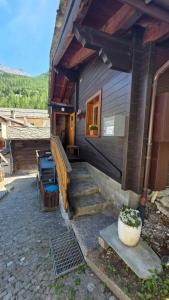 a house with stairs leading up to a door at Lonys Wanderlust Nahe Zermatt in Sankt Niklaus