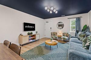 a living room with a blue couch and a table at *NEW ~ Charming, Cozy Apt DWTN Murfreesboro, TN in Murfreesboro