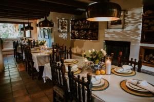 a dining room with a table with plates and candles at Hacienda Del Sol Historic B&B in Taos
