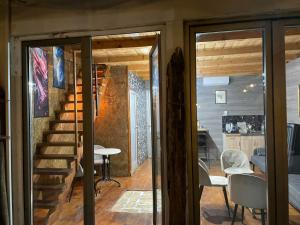 a room with a staircase and a table and chairs at Zmajevo Gnezdo II Water House in Beograd