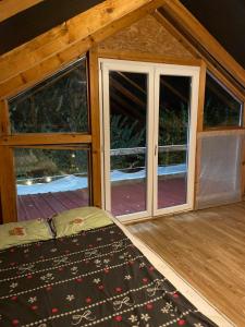 a room with a door and windows in a cabin at Zmajevo Gnezdo II Water House in Beograd