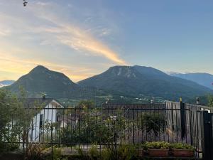 a view of mountains with a fence and mountains at Il fiore del Calisio in Trento