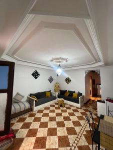 a living room with couches and a checkered floor at Suite 1 in Marrakech