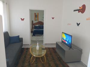 a living room with a couch and a television at Lucian Bed and Breakfast in Goodwood