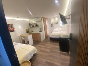 a small room with two beds and a kitchen at La Perla Central Sai in San Andrés