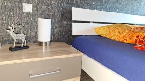 a bedroom with a bed and a lamp on a night stand at Pension Bernburg A2 in Bernburg