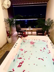 a room with a pool with flowers on the floor at New Stay Offer - Luxury 3BHK with Jacuzzi in Balcony in Jaipur +52 photos