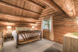 a bedroom with a bed in a log cabin at LOGE Alta Crystal in Enumclaw
