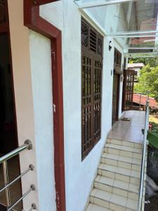 a stairway leading to the front door of a house at Madush House in Haburugala