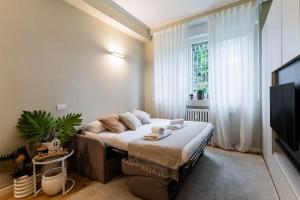 a bedroom with a bed and a large window at Home Studio Luxury in Milan