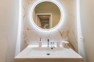 a bathroom with a white sink and a mirror at Home Studio Luxury in Milan +15 photos