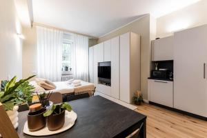 a living room with a bed and a table at Home Studio Luxury in Milan