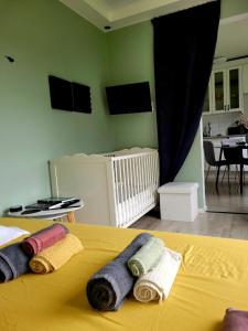 a bedroom with a yellow bed with towels on it at You Can Sleep Here in Hävla Bruk