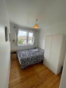 a bedroom with a zebra print bed and a window at Cozy flat in Leafy Greenfields in Galway +3 photos