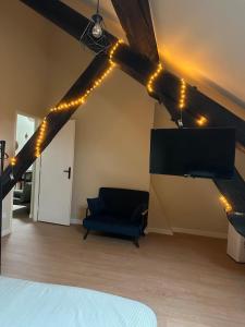 a room with a bed and a couch and lights at Appartement cosy gare chateaucreux in Saint-Étienne +1 photo