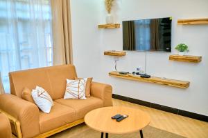 a living room with a couch and a table at JMG Homes & Apartment in Dodoma