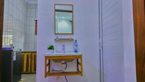 a bathroom with a sink and a mirror on a wall at JMG Homes & Apartment in Dodoma +18 photos