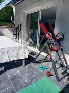 a red chair sitting on a patio next to a table at Les hauts château in Chalifert