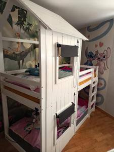 a childs bunk bed with two bunk beds at Les hauts château in Chalifert